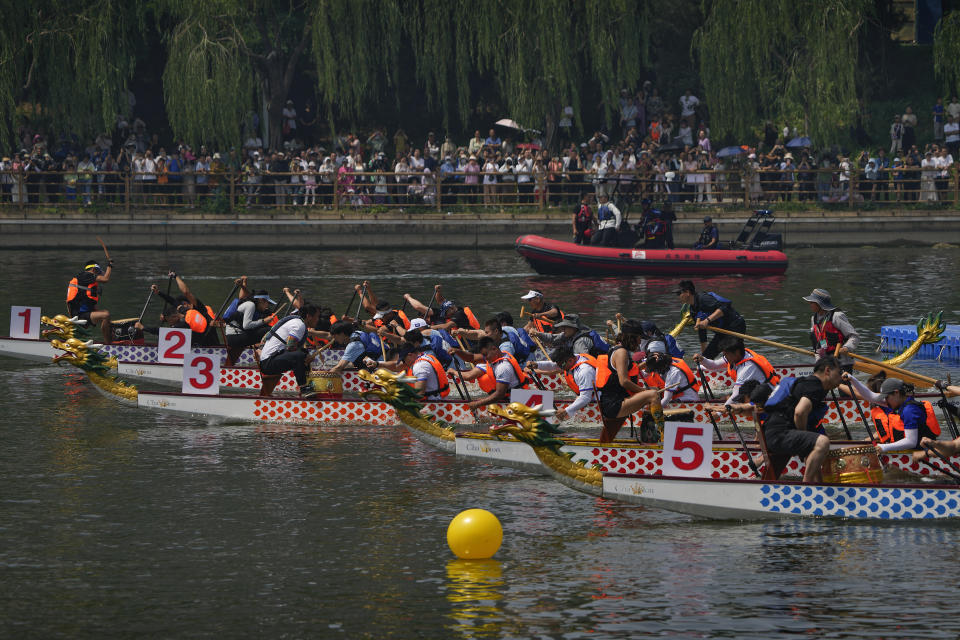 Teams of dragon boat racers paddle their boats as they compete in the Dragon Boat festival at a canal in Tongzhou, on the outskirts of Beijing, Monday, June 10, 2024. The Duanwu festival, also known as the Dragon Boat festival, falls on the fifth day of the fifth month of the Chinese lunar calendar and is marked by celebrations like eating rice dumplings and racing dragon boats. (AP Photo/Andy Wong)