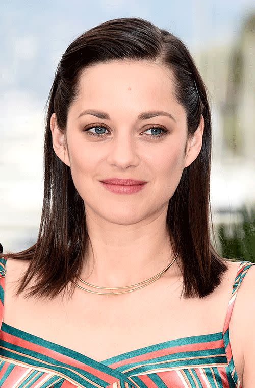 We are envious of how perfect and dewy Cotillard’s porcelain skin looked at the <i>Macbeth</i> photocall in Cannes. Her mulberry lips are a pretty pop of colour, while her straight, pinned back locks are striking.