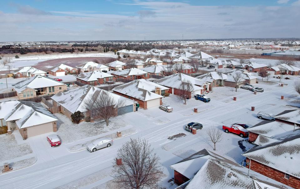 Snow covers the ground in northwest Oklahoma City after a winter storm in Oklahoma City, Sunday, Jan. 14, 2024.