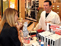 A customer in L'Oreal-owned Kiehl's applies makeup. The natural skin care line comes to Brazil this spring.