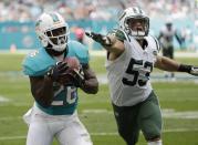 <p>Miami Dolphins running back Damien Williams (26) grabs a pass as New York Jets outside linebacker Mike Catapano (53) is late with the tackle, during the first half of an NFL football game, Sunday, Nov. 6, 2016, in Miami Gardens, Fla. (AP Photo/Wilfredo Lee) </p>