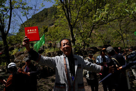 An ethnic Lisu man reacts after winning a crossbow shooting competition in Luzhang township of Nujiang Lisu Autonomous Prefecture in Yunnan province, China, March 29, 2018. REUTERS/Aly Song