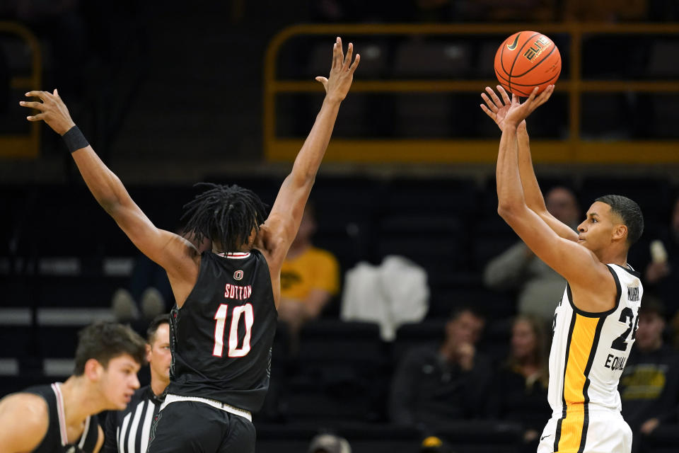 Iowa forward Kris Murray, right, shoots over Omaha forward Marquel Sutton (10) during the first half of an NCAA college basketball game, Monday, Nov. 21, 2022, in Iowa City, Iowa. (AP Photo/Charlie Neibergall)