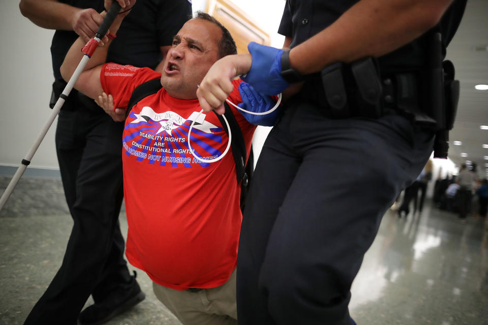 <p>U.S. Capitol Police drag a blind protester out of a Senate Finance Committee hearing about the proposed Graham-Cassidy Healthcare Bill in the Dirksen Senate Office Building on Capitol Hill September 25, 2017 in Washington, DC. Demonstrators disrupted the hearing to protest the legislation, the next in a series of Republican proposals to replace the Affordable Care Act, also called Obamacare. (Photo: Chip Somodevilla/Getty Images) </p>