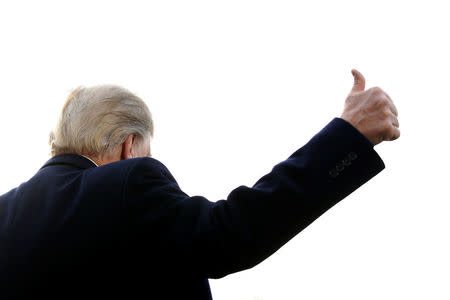 U.S. President Donald Trump gives a thumbs-up to reporters as he departs for travel to Utah from the White House in Washington, U.S. December 4, 2017. REUTERS/Jonathan Ernst