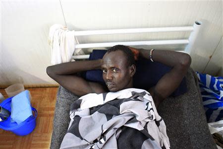 A displaced man with gun shot wounds rests on a bed at a United Nations hospital at Tomping camp, where some 15,000 displaced people who fled their homes are sheltered by the UN, near South Sudan's capital Juba January 7, 2014. REUTERS/James Akena