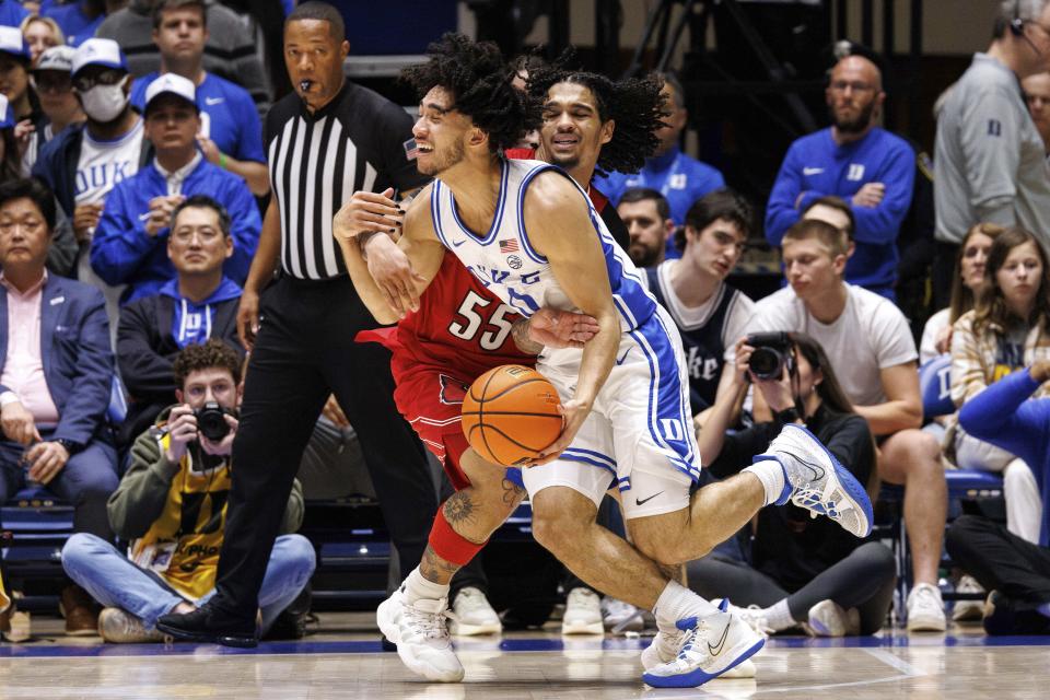 Duke's Jared McCain is fouled by Louisville's Skyy Clark (55) during the first half of an NCAA college basketball game in Durham, N.C., Wednesday, Feb. 28, 2024. (AP Photo/Ben McKeown)