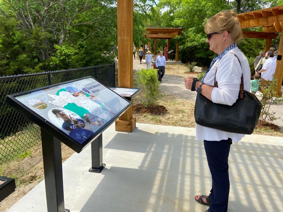 Karla McAlister, of Edmond, reads information featured at one of the stations along The Missions Trail at Falls Creek Baptist Camp & Conference Center near Davis.