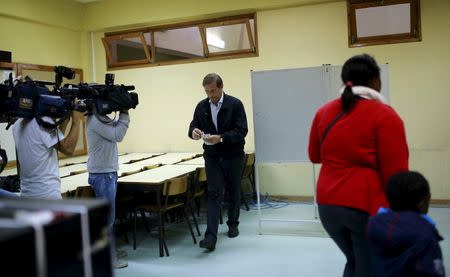 Portugal's Prime Minister and Social Democratic party leader Pedro Passos Coelho (C) casts his ballot during the general election in Massama, on the outskirts of Lisbon, Portugal October 4, 2015. REUTERS/Hugo Correia