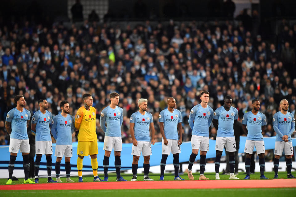 Manchester City players observe a moment’s silence ahead of the derby on Armistice Day