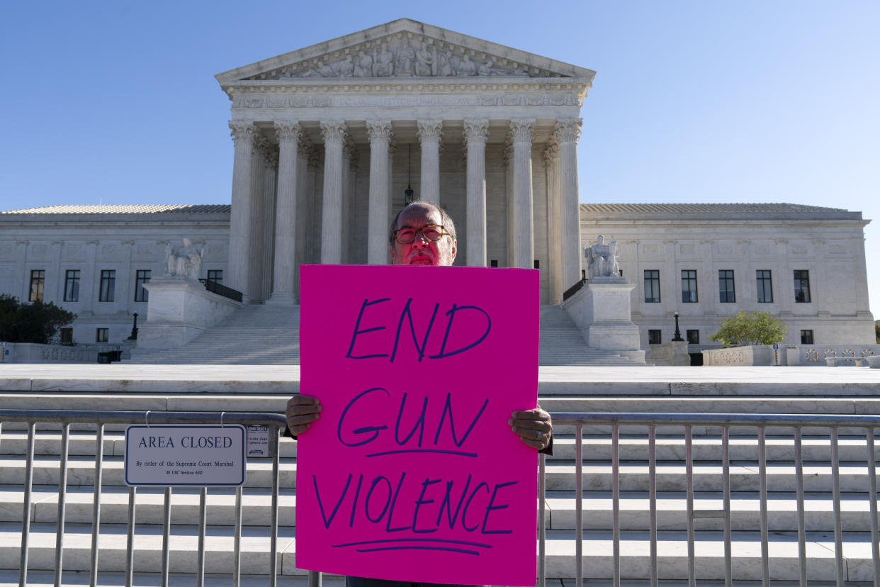 The Rev. Patrick Mahoney holds a sign 