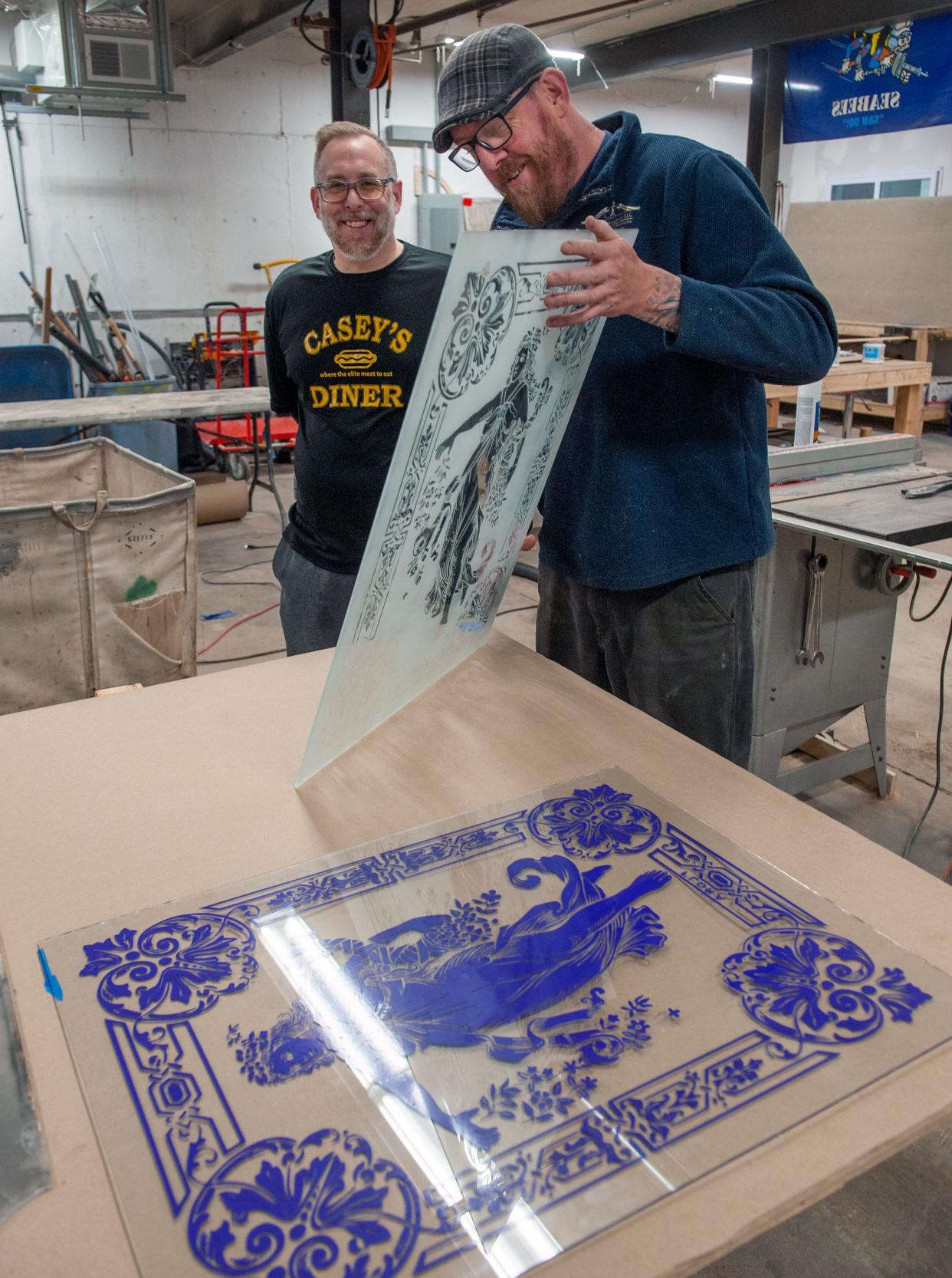 Duane Houghton, right, of Early American Restoration, with Casey's Diner owner Pat Casey in Houghton's Framingham shop, April 2, 2024. The iconic Natick diner's original painted exterior "Quick Lunch" panels were discovered during repairs after a car crash into the diner.