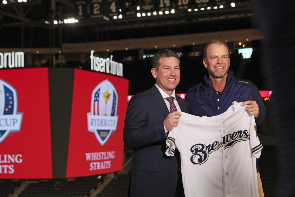 Brian Anderson, left, presents 2020 Ryder Cup captain and Wisconsin native Steve Stricker with a Milwaukee Brewers jersey. Anderson will return to Brewers TV broadcasts in 2024, though like previous years he'll split time with Turner sports.