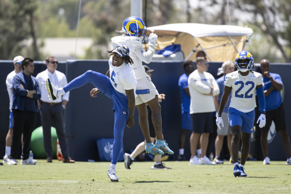 Los Angeles Rams cornerback Jalen Ramsey, left, and Troy Hill, center, celebrate after a good play during NFL football practice Monday, July 25, 2022, in Irvine, Calif. (AP Photo/Kyusung Gong)