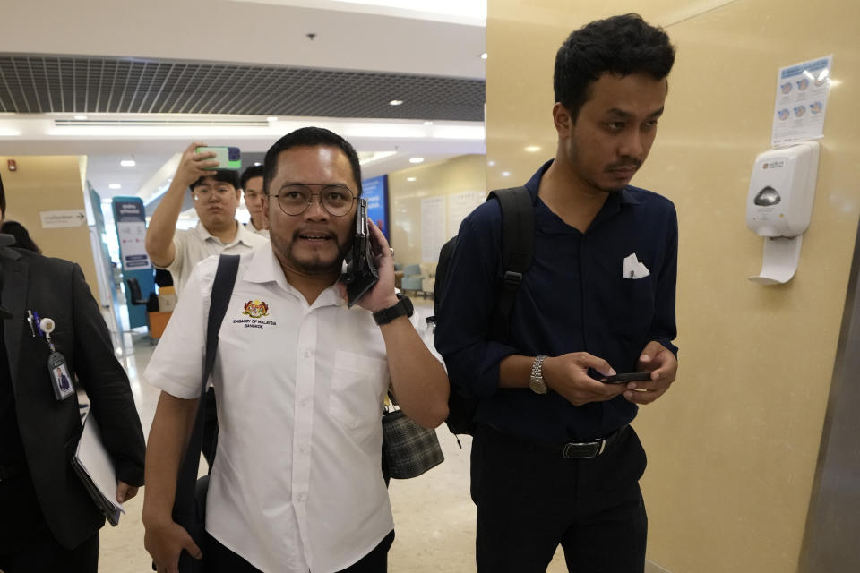 A staff member, left, from the Malaysian Embassy arrives at Samitivej Srinakarin Hospital in Bangkok, Thailand, Wednesday, May 22, 2024, to visit passengers from Malaysia injured in a Singapore Airlines flight that hit severe turbulence over the Indian Ocean on Tuesday. The Singapore Airlines flight descended 6,000 feet (around 1,800 meters) in about three minutes, the carrier said Tuesday. A British man died and authorities said dozens of passengers were injured, some severely. (AP Photo/Sakchai Lalit)