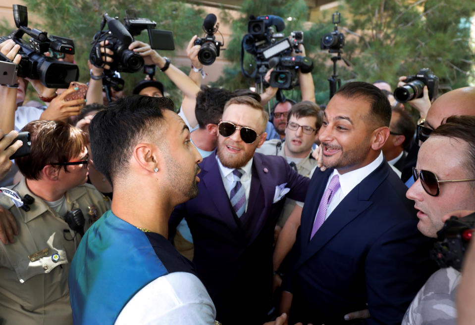 Boxer Paulie Malignaggi (L) talks with UFC lightweight champion Conor McGregor (C) of Ireland and McGregor’s manager Audie Attar at Toshiba Plaza in Las Vegas, Nevada U.S. on August 22, 2017. (Reuters)