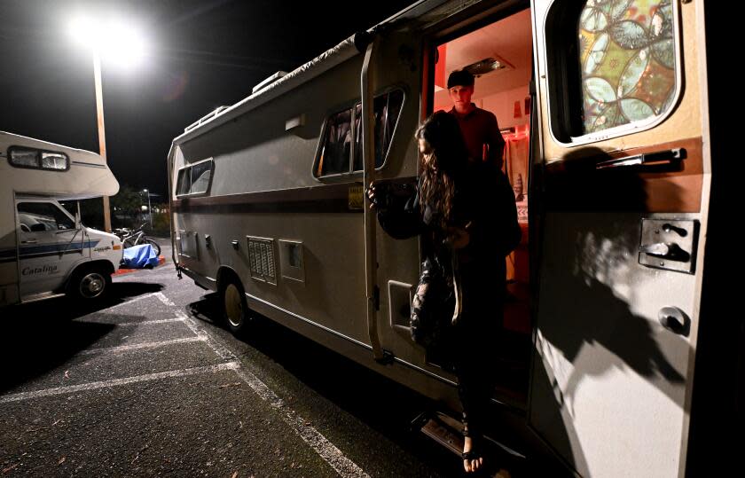 Arcata, California November 17, 2023-Students Brad Butterfield and Maddie Montiel prepare to move their campers parked at a Cal Poly Humboldt lot. The university recently issued an eviction notice for students who sleep in their vehicles. (Wally Skalij/Los Angeles Times)