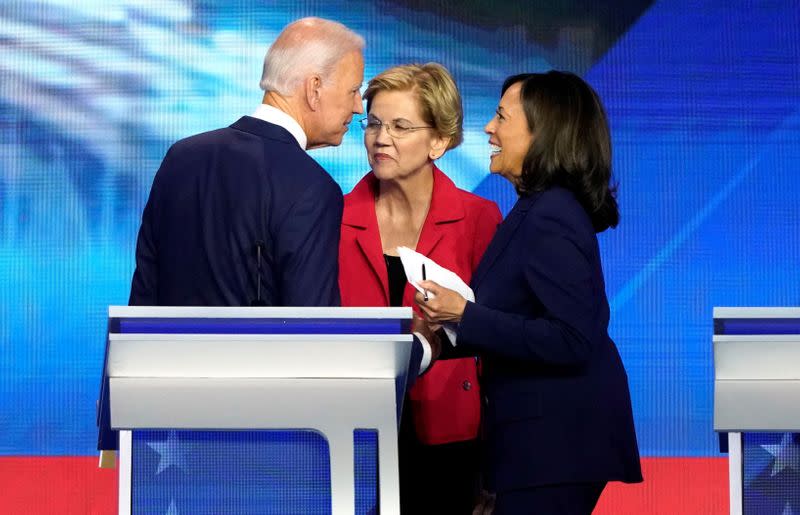 FILE PHOTO: Former Vice President Joe Biden talks with Senator Elizabeth Warren (C) and Senator Kamala Harris (R) after the conclusion of the 2020 Democratic U.S. presidential debate in Houston