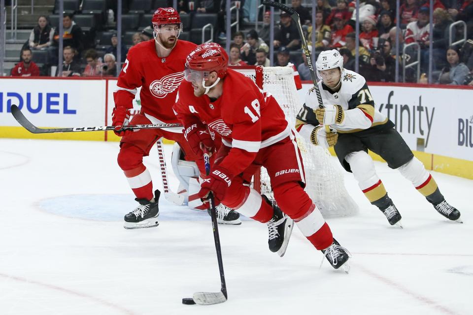 Detroit Red Wings center Andrew Copp (18) is pursued by Vegas Golden Knights center William Karlsson (71) during the first period of an NHL hockey game Saturday, Dec. 3, 2022, in Detroit. (AP Photo/Duane Burleson)