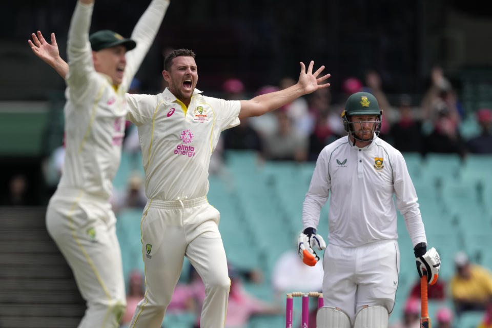 Australia's Josh Hazlewood, center, and teammate Marnus Labuschagne appeal for a LBW decision on South Africa's Heinrich Klaasen, right, during the fourth day of their cricket test match at the Sydney Cricket Ground in Sydney, Saturday, Jan. 7, 2023. (AP Photo/Rick Rycroft)