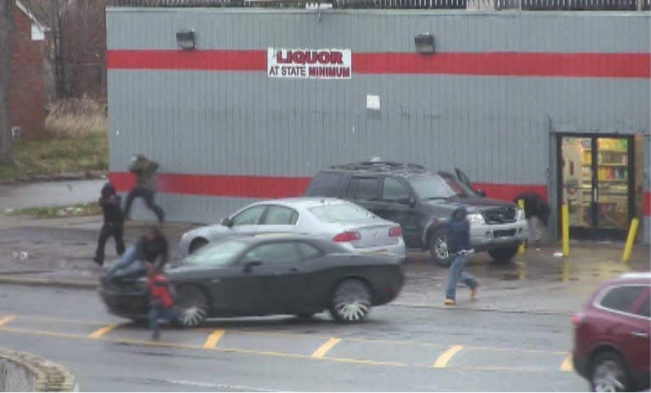 FBI pole cameras capture two Detroit gang members opening fire on a vehicle outside a market on the city's east side on Dec. 1, 2015.  A rival gang member and 13-year-old girl inside the car were killed. Two children sitting on the roof of the car were injured.