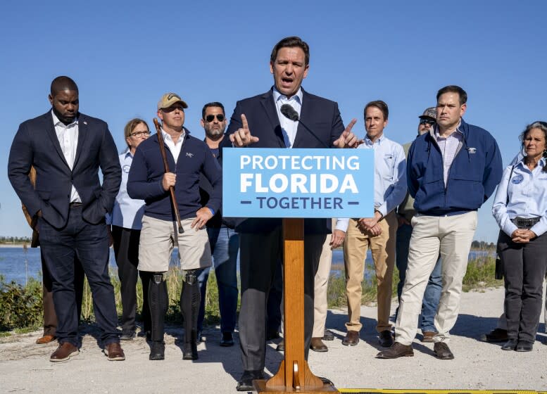 Florida Gov. Ron DeSantis speaks during a news conference with U.S. Reps. Byron Donalds, R-Fla., left, Brian Mast, R-Fla., third left, Sen. Marco Rubio, R-Fla., second right, and others at a stormwater treatment area in western Palm Beach County, Fla., on Monday, Jan. 31, 2022. (Greg Lovett/The Palm Beach Post via AP)