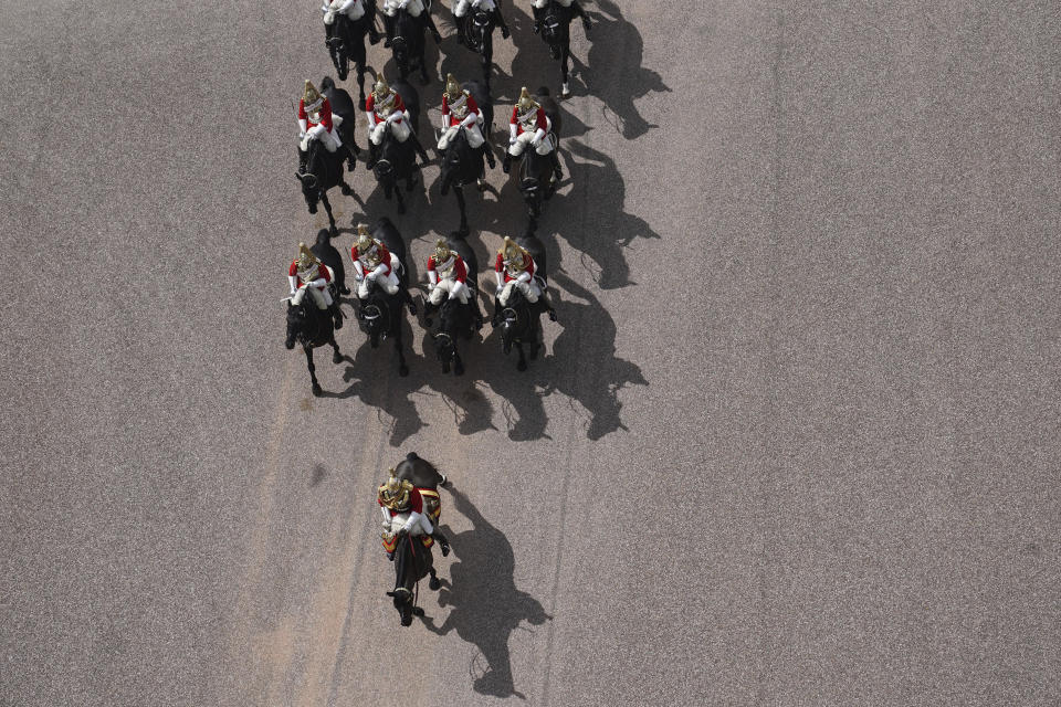 Members of the Household Cavalry arrive at Windsor Castle, Windsor, England, during a military ceremony to mark the official birthday of Queen Elizabeth II, Saturday June 12, 2021. In line with government advice The Queen's Birthday Parade, also known as Trooping the Colour, will not go ahead in its traditional form. (Steve Parsons/Pool via AP)