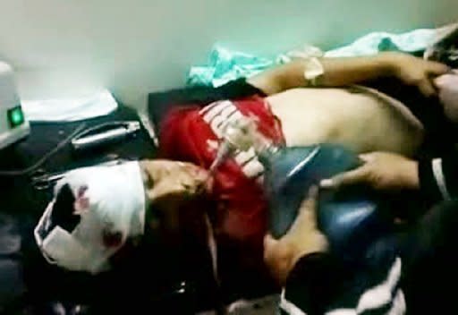 An image from a video uploaded on YouTube on Saturday shows a Syrian child receiving medical help at a makeshift hospital in Rastan, north of Homs. The new head of Syria's main opposition group called Sunday for mass defections from a Syrian regime struggling to survive by carrying out massacres, as the death toll in the uprising topped 14,000