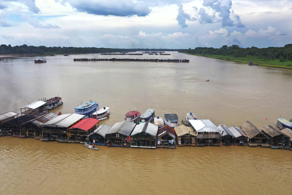 FILE - Dredging barges operated by illegal miners converge on the Madeira river, a tributary of the Amazon River, searching for gold, in Autazes, Amazonas state, Brazil, Nov. 25, 2021. Much like brown and black tributaries that feed the Amazon River, gold illegally mined in the rainforest mixes into the supply chain and melds with clean gold to become almost indistinguishable. (AP Photo/Edmar Barros, File)