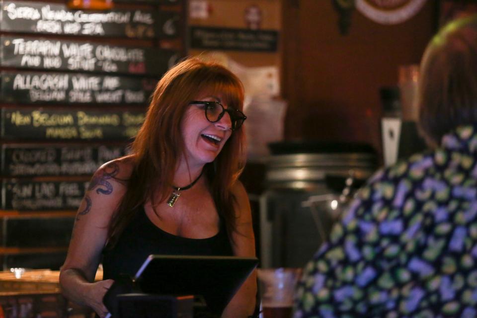 Linda Moore laughs with bar guests at her restaurant the Kilted Mermaid as election results come in Tuesday, Nov. 8, 2022, in Vero Beach. “I am honored by the faith of the City of Vero Beach,” Moore said. “I will do my very best to guide the city in a direction that is good for everyone. 