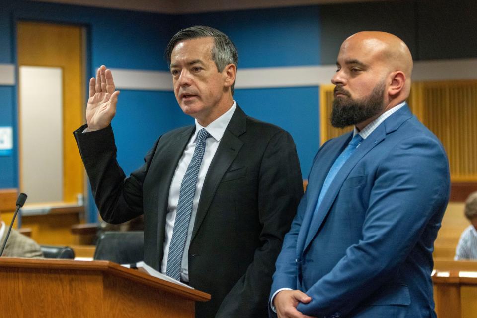 Attorney Scott Grubman, right, stands with his client, Kenneth Chesebro as Chesebro is sworn in during a plea deal hearing, Friday, Oct. 20, 2023, at the Fulton County Courthouse in Atlanta. Chesebro, who was was charged alongside former President Donald Trump and 17 others with violating the state's anti-racketeering law in efforts to overturn Trump's loss in the 2020 election in Georgia, pleaded guilty to a felony just as jury selection was getting underway in his trial. (Alyssa Pointer/Pool Photo via AP)