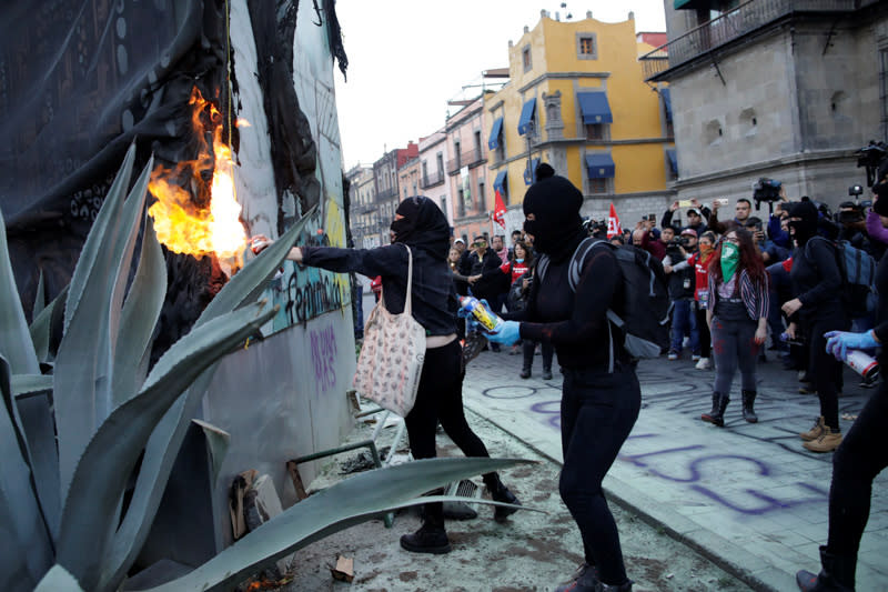 People take part in a protest against gender-based violence in downtown of Mexico City