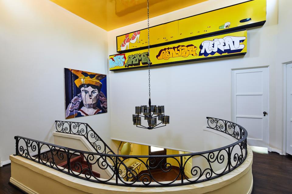 The house’s curved staircase takes you to a landing with doors that open to two large bedroom suites, as well as the hidden staircase to the kitchen. The painting on the wall is by an artist named Ella Kruglyanskaya. “I had seen her work a few years ago at Frieze, and it was all sold out,” says Ronson. “I had been waiting for years for her latest show to be done, and this is one of those pieces from it. I actually have a second one in my place in New York.” The two graffiti works are from the Street Market installation by artists Barry McGee, Todd James, and Stephen Powers. Showing at Dietch Projects in 2000, the artists worked to present an apocalyptic version of an urban street.