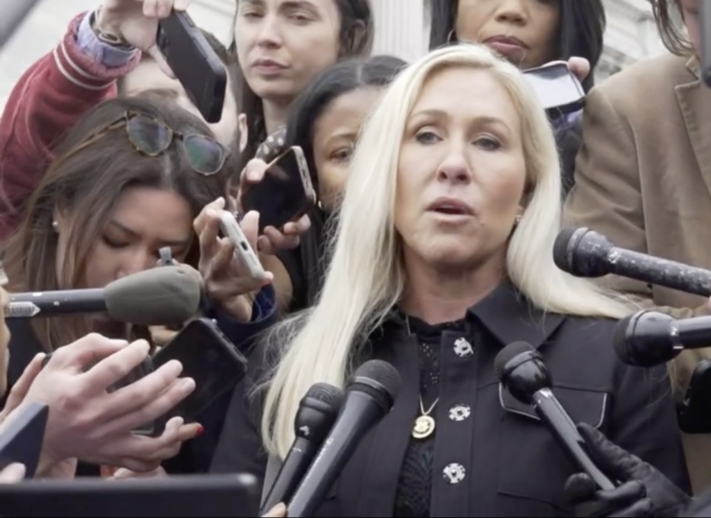 A woman speaking into microphones