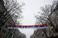 A street decorated with Serbian flags in the northern, Serb-dominated part of ethnically divided town of Mitrovica, Kosovo, Friday, Dec. 14, 2018. Kosovo's parliament overwhelmingly approved the formation of an army, a move that has angered Serbia which says it would threaten peace in the war-scarred region. (AP Photo/Darko Vojinovic)