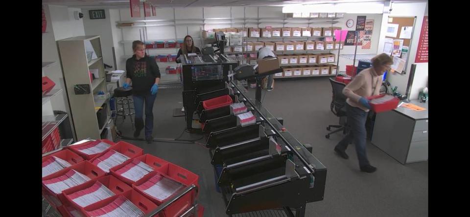 In a screengrab from video, elections workers with the Auditor’s Office sort ballots in the basement of the Whatcom County Courthouse on Election Day.