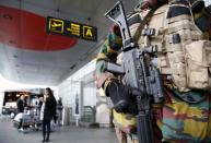 A Belgian soldier stands guard at the entrance of Zaventem international airport near Brussels, November 22, 2015, after security was tightened in Belgium following the fatal attacks in Paris. REUTERS/Francois Lenoir