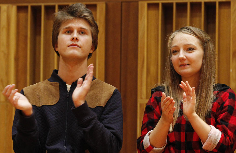 Aleksandra Swigut, right, applauds Tomasz Ritter, left, of Poland who is declared the winner of the 1st Chopin Competition on Period Instruments in Warsaw, Poland, Thursday, Sept. 13, 2018. The announcement took place after each of the six finalists played a Chopin concerto accompanied by the Amsterdam-based Orchestra of the 18th century. (AP Photo/Czarek Sokolowski)