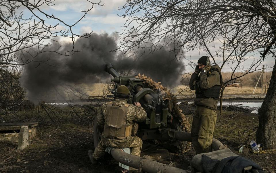 Ukrainian troops fire a 105mm Howitzer near Bakhmut - AFP