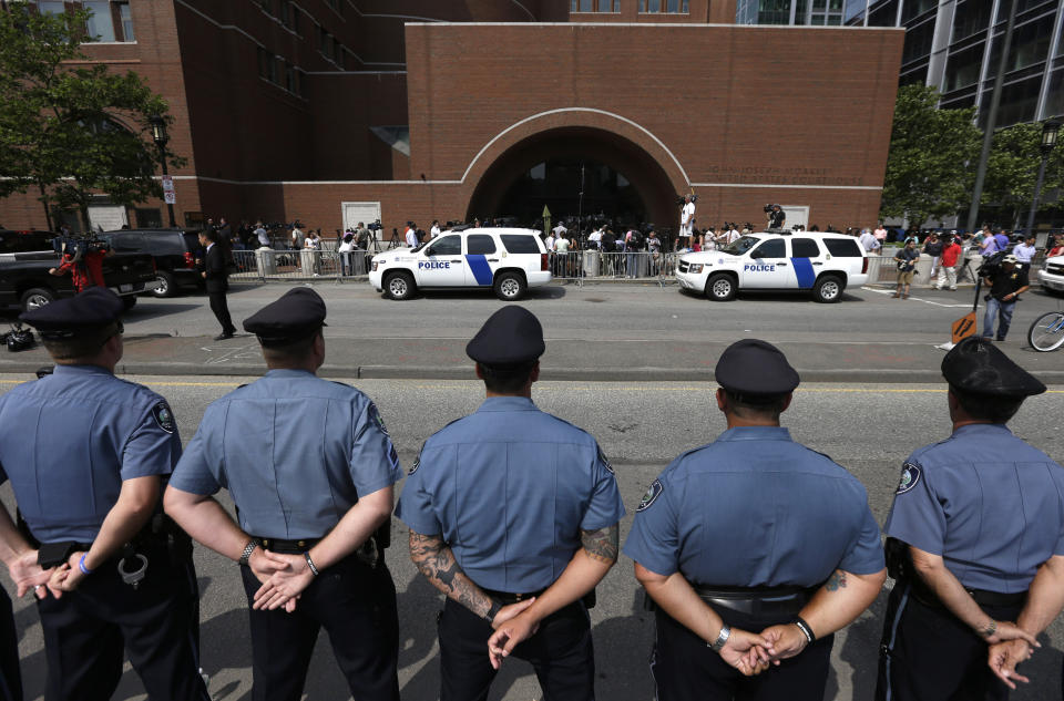 FILE — Massachusetts Institute of Technology police officers form a line in front of the federal courthouse in Boston prior to the arraignment of Boston Marathon bomber Dzhokhar Tsarnaev, July 10, 2013. MIT police officer Sean Collier was killed by Tsarnaev and his brother, Tamerlan, during the manhunt after they set a pair of pressure-cooker bombs among the crowd of spectators watching the marathon finish on Boylston Street, killing three and wounding hundreds more. (AP Photo/Steven Senne, File)