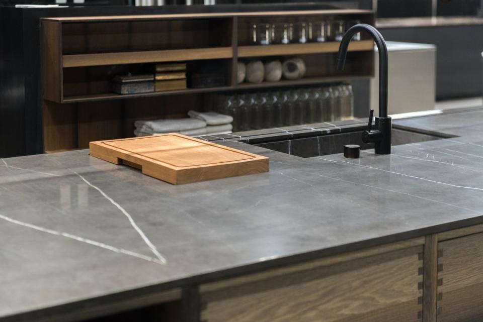 Dark gray soapstone countertop island in an industrial kitchen