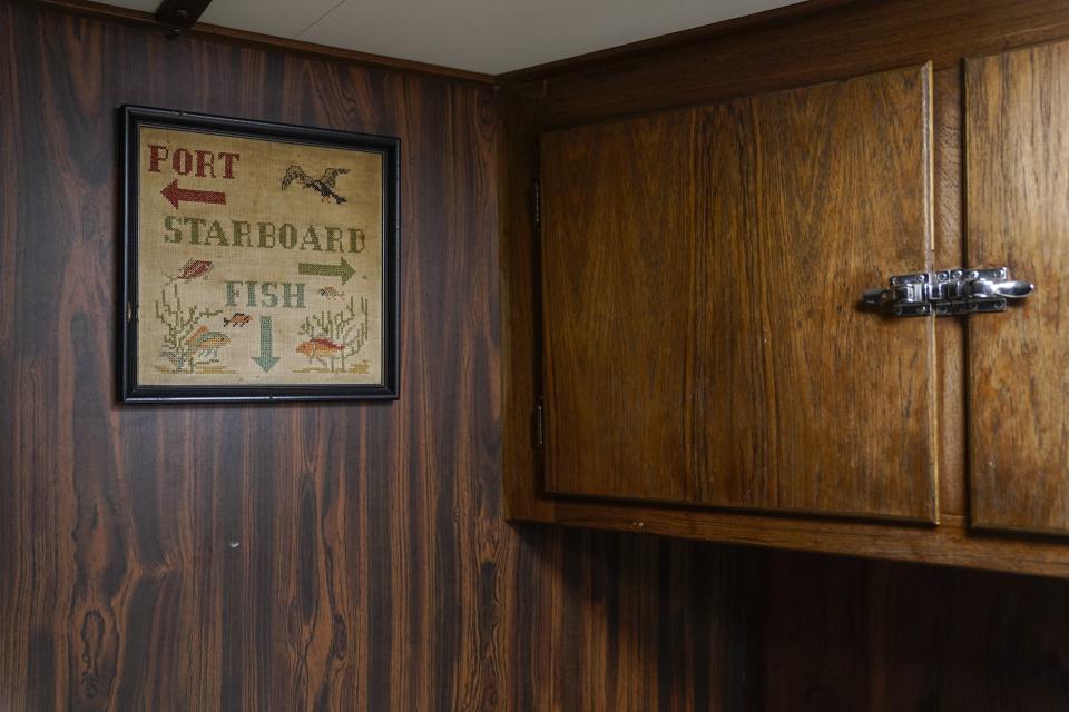 A sign hangs inside the galley on a fishing boat, Monday, June 26, 2023, in Kodiak, Alaska. (AP Photo/Joshua A. Bickel)