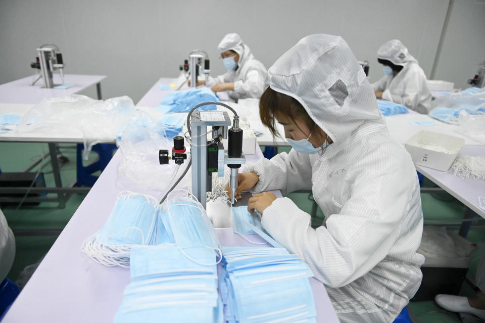 Employees make face masks on a production line at a glove factory, which has started producing face masks as overseas orders for masks at an all time high amid the coronavirus outbreak, on May 16, 2020 in Shenyang, Liaoning Province of China. (Yu Haiyang / China News Service via Getty Images file)