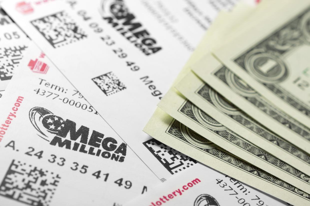 Philadelphia, United States - March 13, 2011: Many Mega Millions lottery tickets and one dollar bills. Mega Millions is Americas biggest jackpot game. It is held in 42 states and has jackpots starting at $12 million.