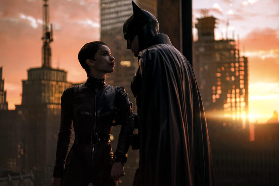 This image released by Warner Bros. Pictures shows Zoe Kravitz, left, and Robert Pattinson in a scene from "The Batman." “The Batman” is still going strong three weeks into its theatrical run, with a tight grip on the top spot at the box office. Robert Pattinson’s debut as the Dark Knight earned an additional $36.8 million over the weekend, according to studio estimates Sunday, March 20, 2022. It also slid past the $300 million mark ahead of projections.<span class="copyright">Jonathan Olley—Warner Bros. Pictures/AP</span>