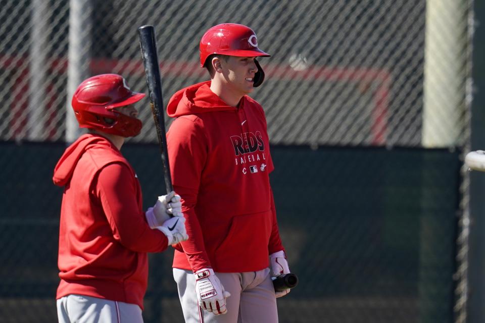 Cincinnati Reds' Tyler Stephenson, right, and Tucker Barnhart await their turn for batting practice during baseball spring training Thursday, Feb. 25, 2021, in Goodyear, Ariz. (AP Photo/Ross D. Franklin)