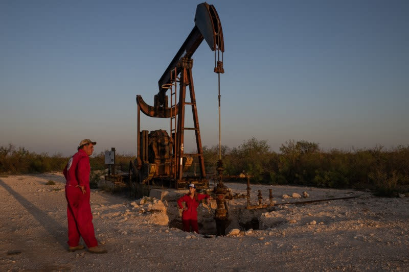 Oil well specialist and lawyer survey pumpjack with leaking surface casing in Ward County, Texas