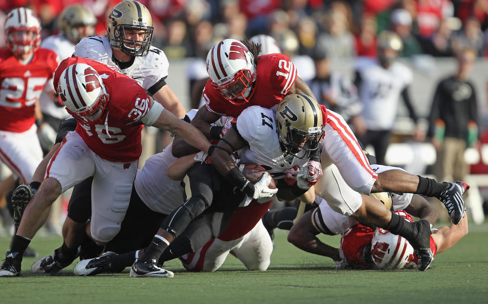 MADISON, WI - NOVEMBER 05: Dezmen Southward #12 and Ethan Armstrong #36 of the Wisconsin Badgers bring down Akeem Hunt #11 of the Purdue Boilermakers at Camp Randall Stadium on November 5, 2011 in Madison Wisconsin. (Photo by Jonathan Daniel/Getty Images)