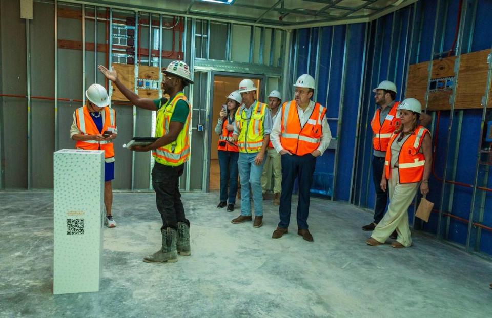 Field Superintendent Edward Jackson (center) leads a tour with guests attending the topping off ceremony at the construction site where the new UHealth at SoLé Mia medical facility, is been built in North Miami. Guests could scan a QR code to see an example of what the completed operating room would look like. The seven-story, 363,000-square-foot medical center will include cancer specialists from Sylvester Comprehensive Cancer Center, advanced vision care from the No. 1 ranked eye hospital in the country, Bascom Palmer Eye Institute; urological treatments from the Desai Sethi Urology Institute, on Friday April 05, 2024.