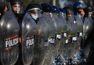 Police carry out evictions at a squatters camp in Guernica, Buenos Aires province, Argentina, Thursday, Oct. 29, 2020. A court ordered the eviction of families who are squatting here since July, but the families say they have nowhere to go amid the COVID-19 pandemic. (AP Photo/Natacha Pisarenko)